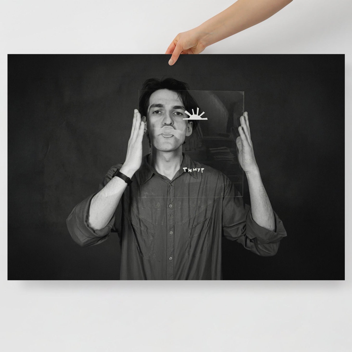 Hand holding Timur Novikov b&w photo self-portrait large print. www.timurnovikov.art